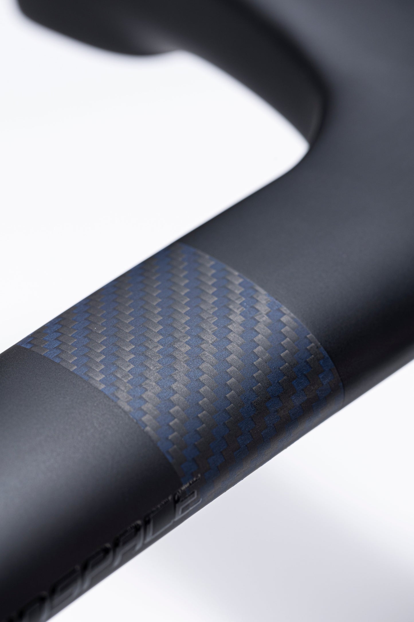 Matte black Zero K integrated handlebar with blue and gray carbon weave accent and embossed branding detail.