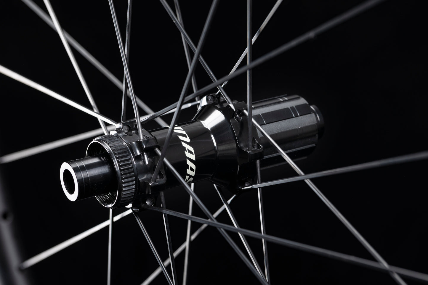 Close-up of UNAAS HARD H50D disc brake wheelset hub, matte black with white UNAAS branding and silver spokes.