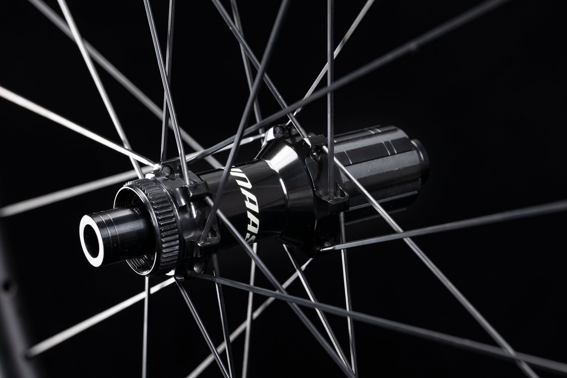 Close-up of UNAAS HARD H50D disc brake wheelset hub, matte black with white UNAAS branding and silver spokes.