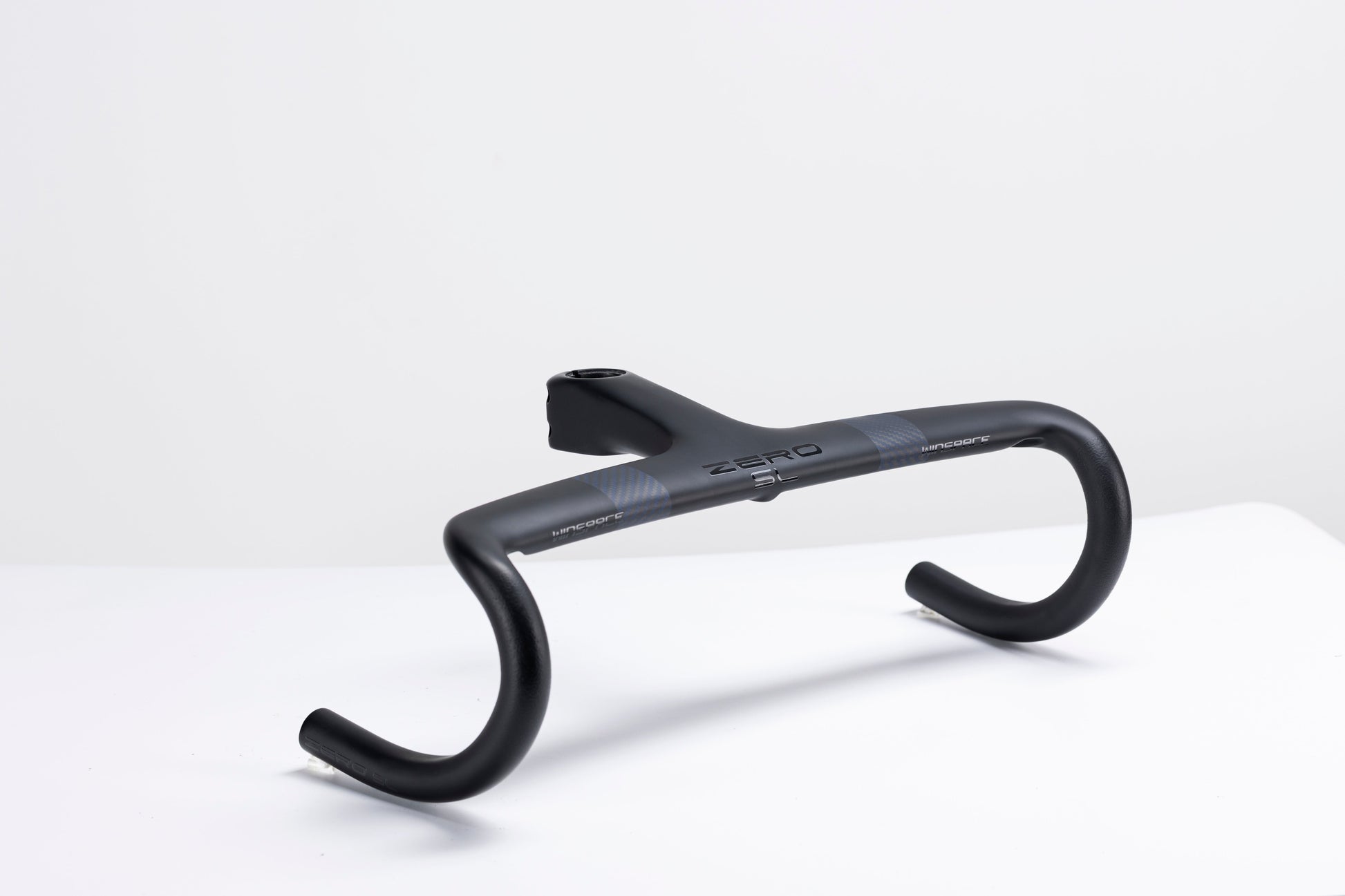 Matte black carbon fiber Zero integrated handlebar with aerodynamic design and checkered pattern detail.