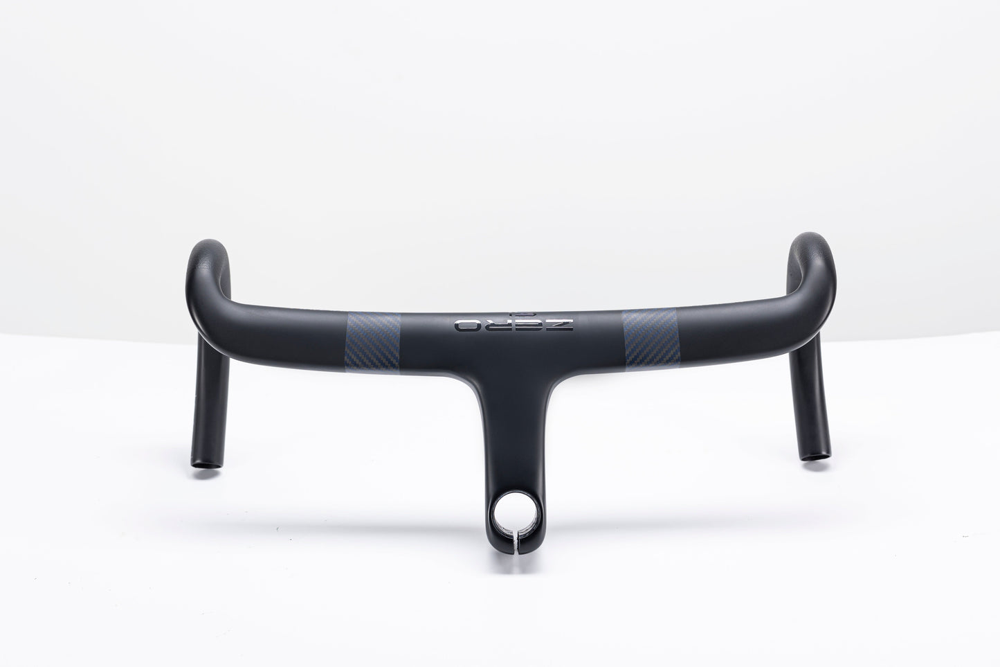 Matte black Zero K integrated carbon fiber handlebar with subtle gray carbon weave and minimalist branding.